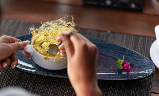 alt-text Beautifully decorated bowl of food, elegantly presented on plates, t Parallel Hotel Udaipur