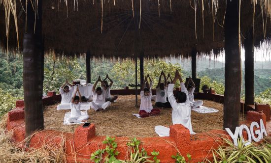 alt-text people practicing yoga inside the yoga centre - Holistic Stay Eco Resort, Kannur