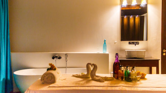 interior of a massage Spa in port Blair table with towel swans, towel roll and oil bottles placed on it - Symphony Samudra Beachside Jungle Resort And Spa, Port Blair