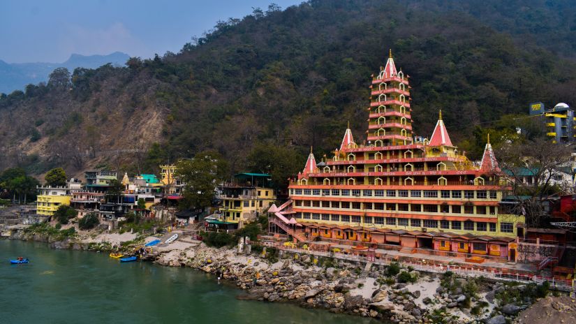 a red building on the bank of the river