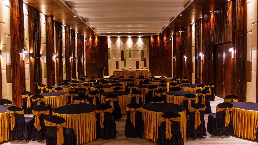 Banquet room set up with a black and yellow theme decor 