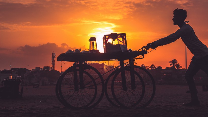 A hawker in chennai with the sun in the background