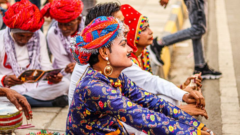 Rajasthani folk artists sitting on the sideways of a road