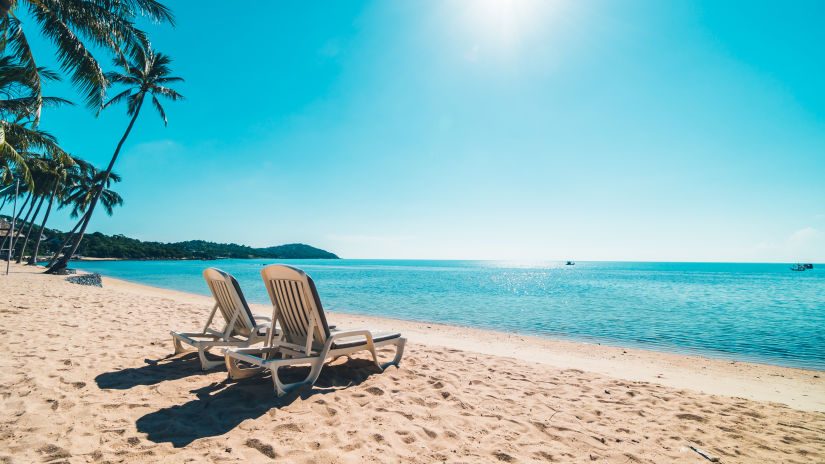 beautiful-tropical-beach-sea-with-chair-blue-sky