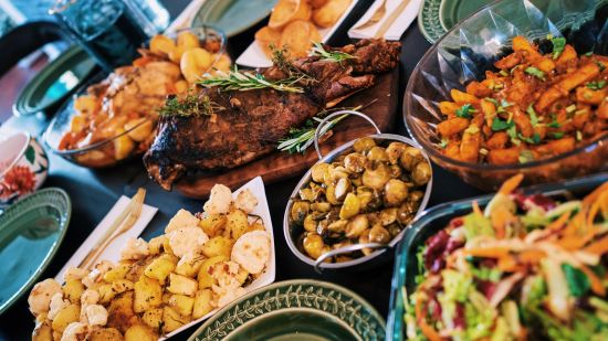 roast meat and side dishes served on a table