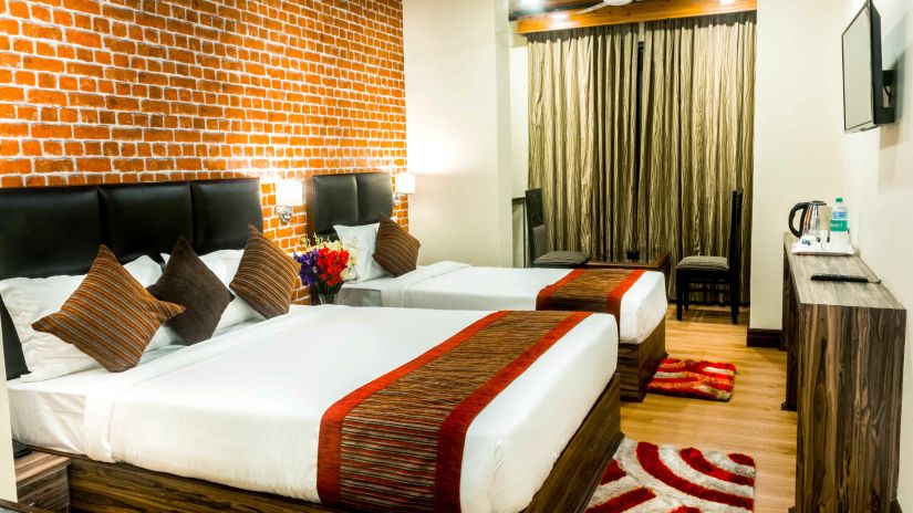 Premium room at Tin Tin Boutique Hotel with a double bed and a single bed