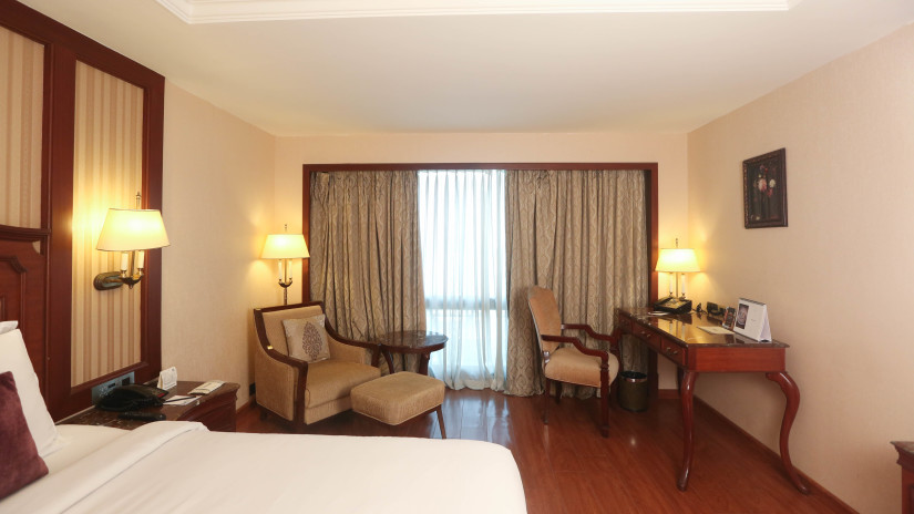 Cosy room with modern interiors, king size bed and sofa at Hablis Hotel, Chennai