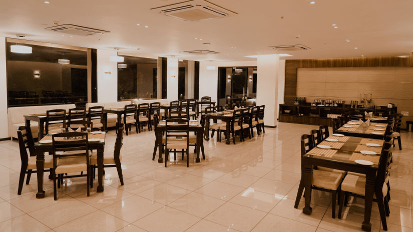 Pride Ranakpur Resort Convention Centre - interior view of the property restaurant featuring numerous tables and chairs