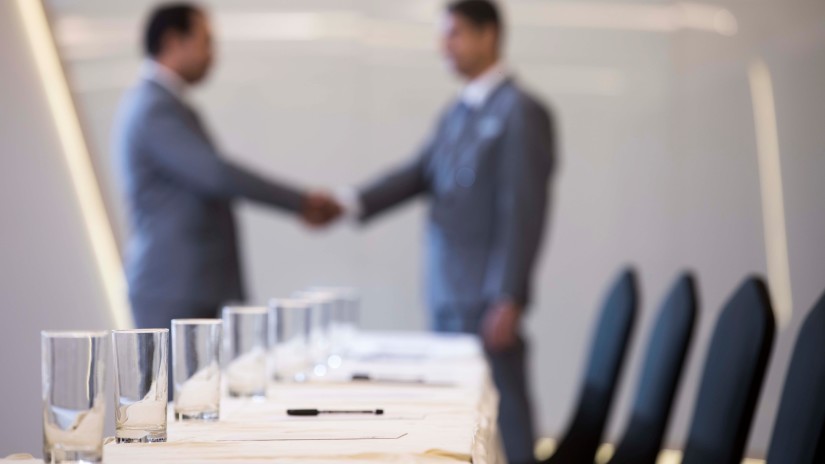 Two businessmen shaking hands - Hablis Hotel, Chennai