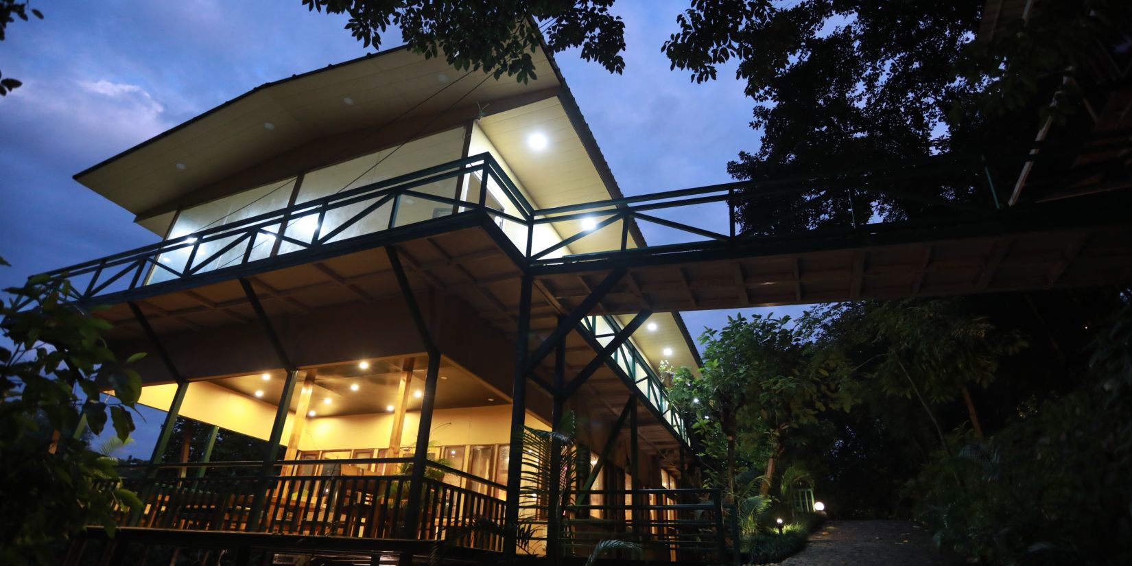 exterior of one of the cottages at The Sal Woods Forest Resort & Spa around sunset