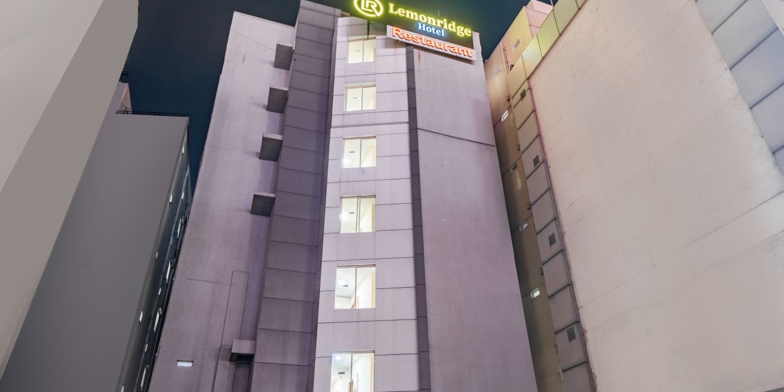 Nighttime view of the hotel's facade at Lemonridge Hotels.