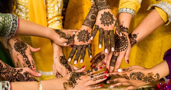 alt-text bridesmaids showing henna covered hands