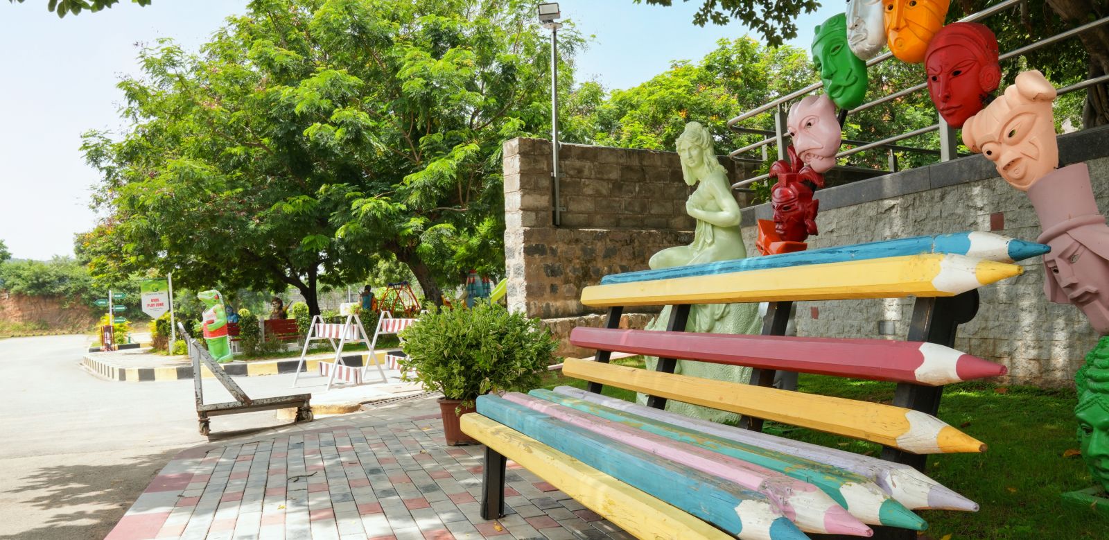 a pencil shaped seats surrounded by trees at Greens Inn