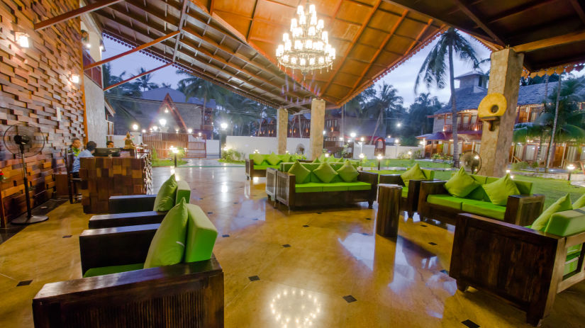 Sofas with chandelier in the centre inside the restaurant - Symphony Summer Sand Beach Resort And Spa, Neil Island