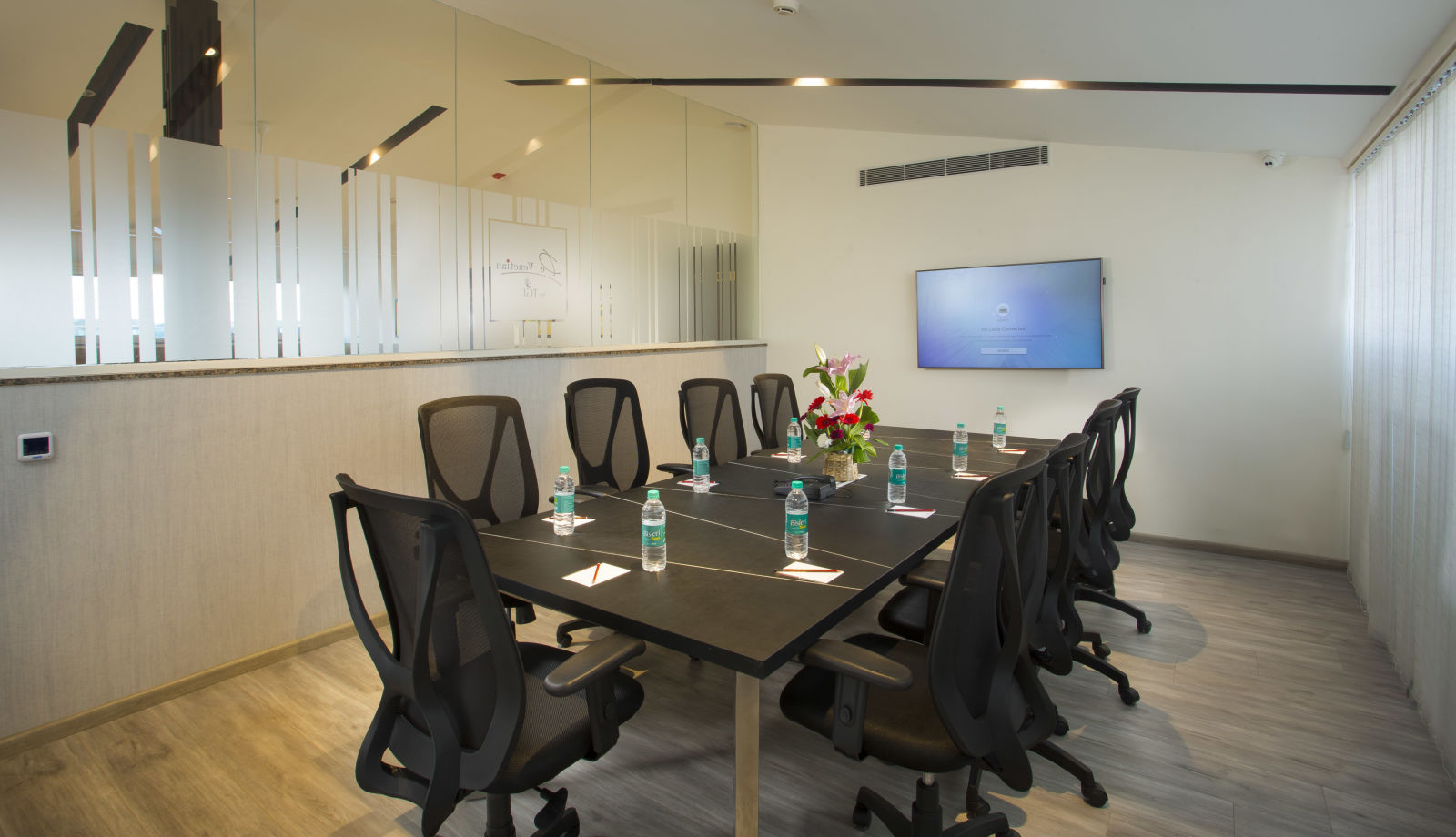 Another angle of the conference room showing a glass partition and a whiteboard - De Venetian by TGI, Brookefield