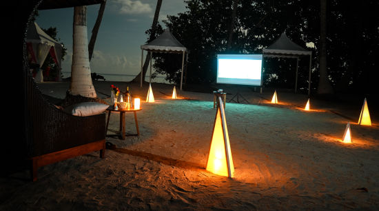 alt-text White screen with a movie showing on the beach - Coral Reef Resort Havelock