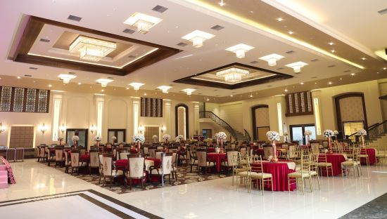 alt-text A warmly lit interior of The Grand Velvet decked with chairs and table at Ramada by Wyndham Kapurthala