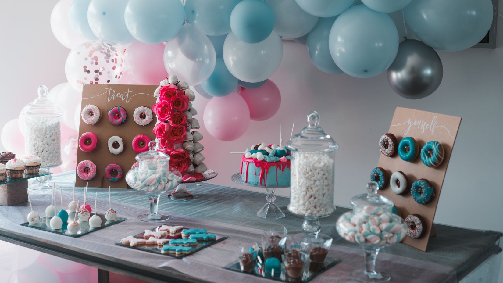 a desk decorated with balloons and other decorations