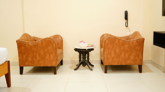 an image featuring two sofa chairs and a table - A M Suites