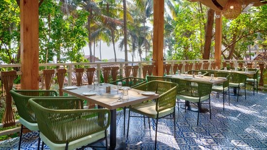 Outdoor seating arrangement at the restaurant in Aralea Beach Resort by Stone Wood, Morjim