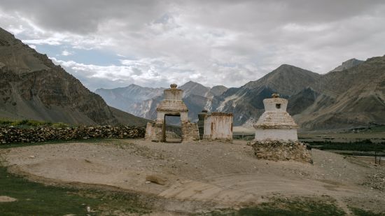 stone structure surrounded by mountains