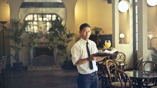 Waiter with a tray @ Lamrin Ucassaim Hotel, Goa