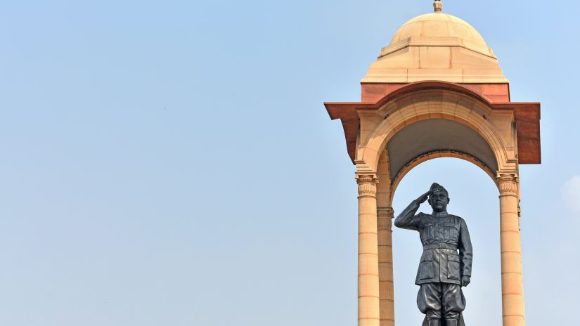 a statue of freedom fighter Subhash Chandra Bose captured from a lower angle with a clear blue sky as the backdrop