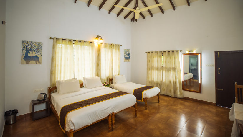 Overview of the deluxe triple room with king and a single bed - Capitol Village Resort, Madikeri