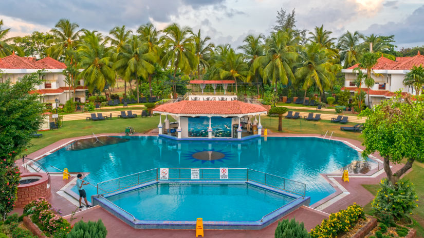 aerial view of the swimming pool at heritage village resort and spa in goa