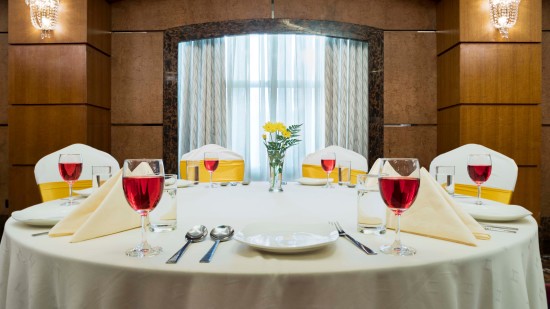 A dining table in magnum hall at Hablis Hotel, Chennai