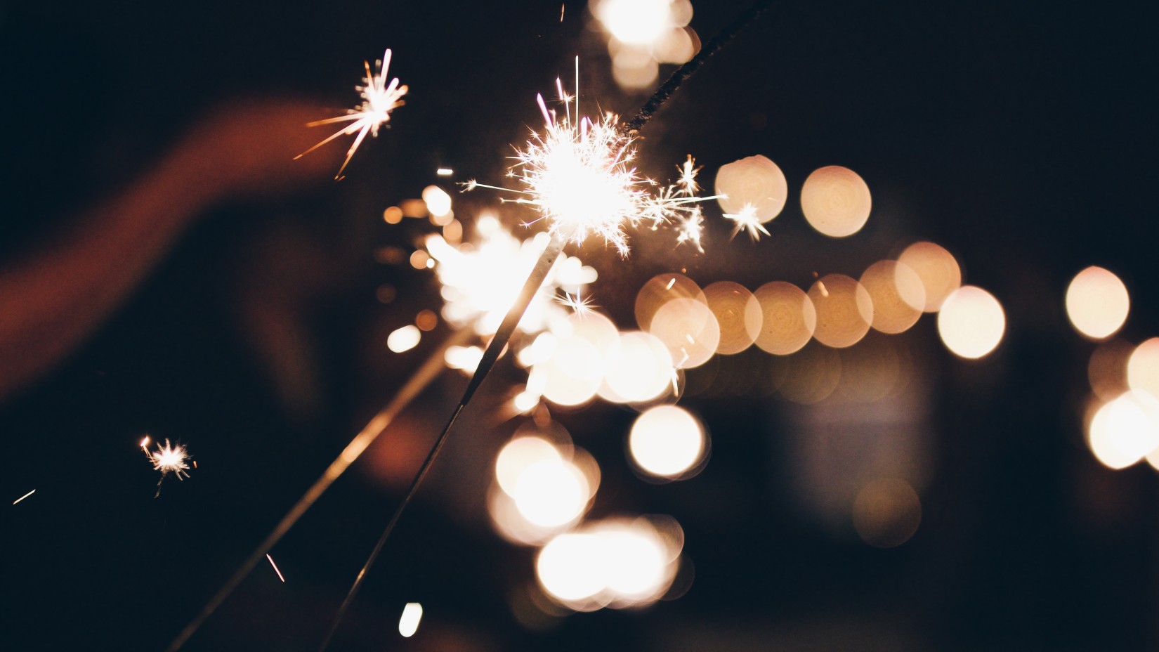 A close shot of a lit up cracker at night