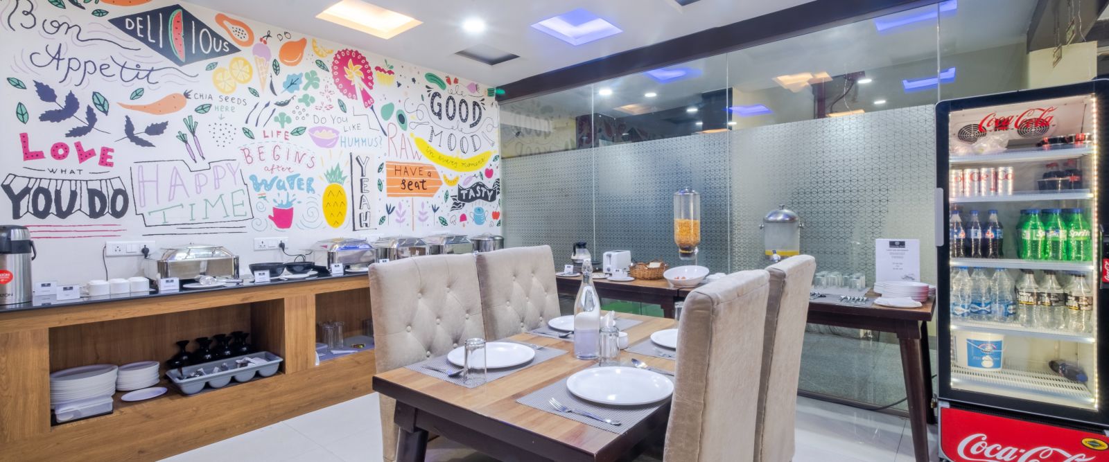 Restaurant featuring artistic wall decor, small dining table and beverage cooler at Lemonridge Hotels