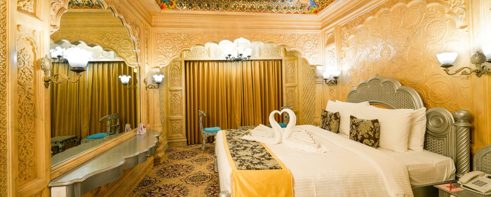 Themed room at Sitara Luxury Hotel with a king size bed and side tables