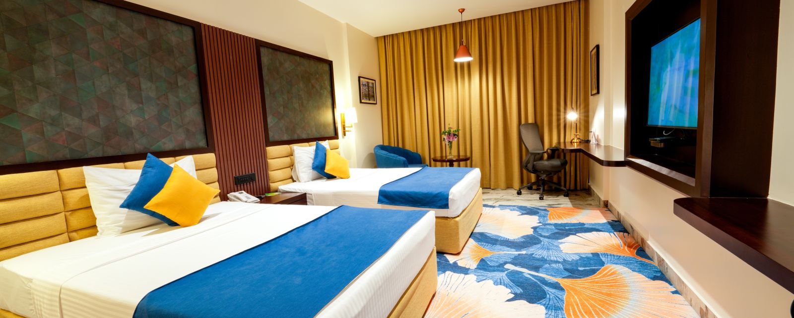 Room at Sitara Luxury Hotel with twin beds and a television