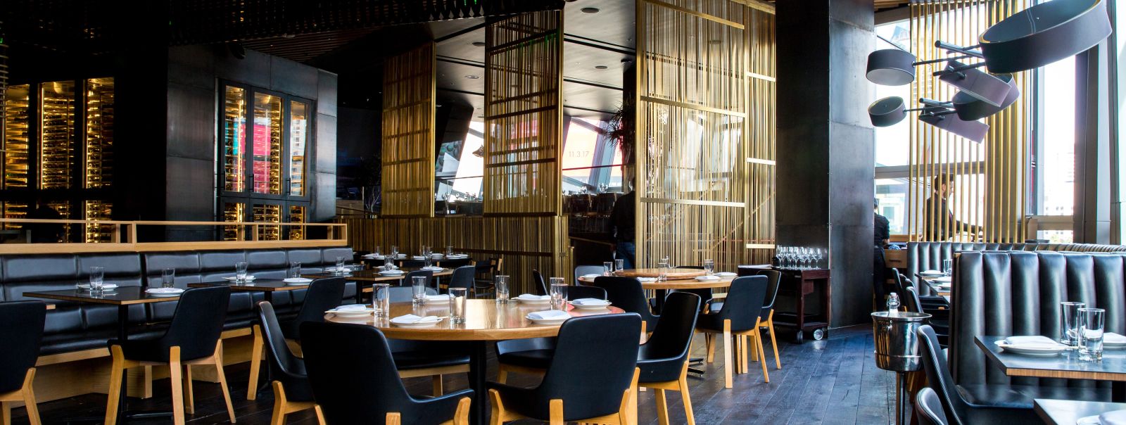 Seating arrangements inside a restaurant with the sun light shining through the windows