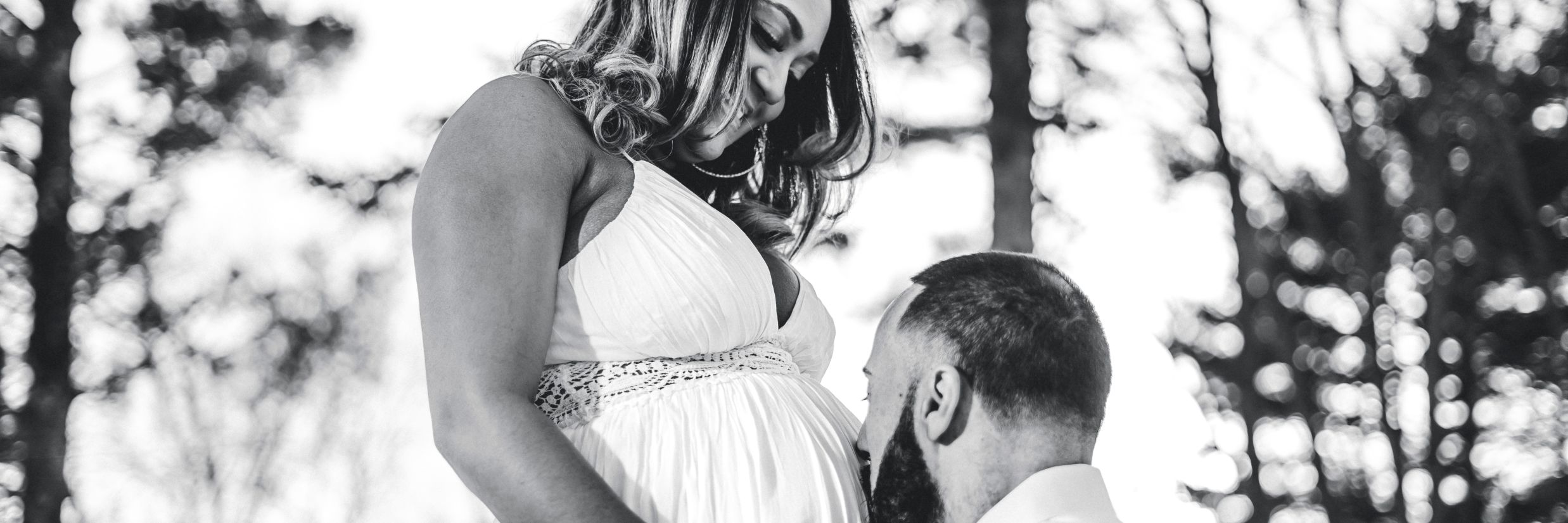 A man kisses his pregnant wife on her belly - Babymoon near Delhi