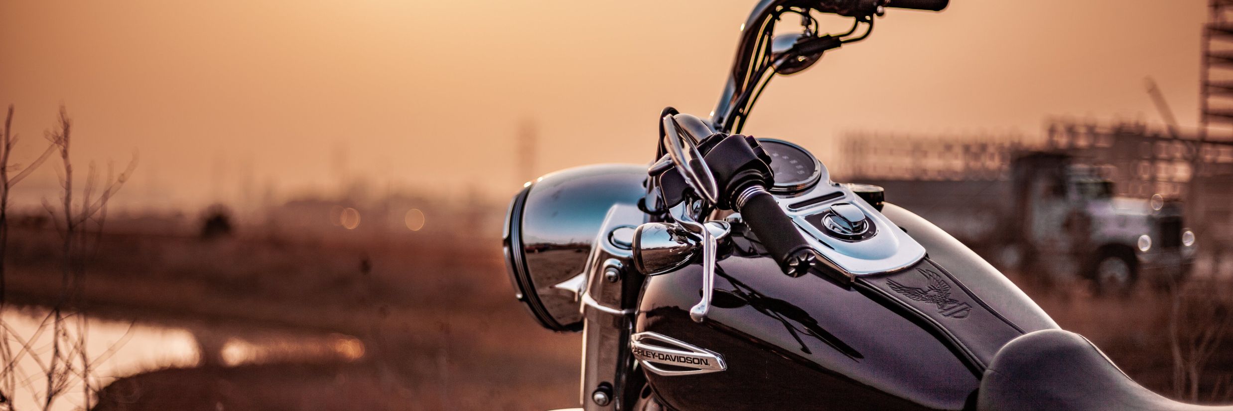 a sunset shot of a parked bike on the side of the road