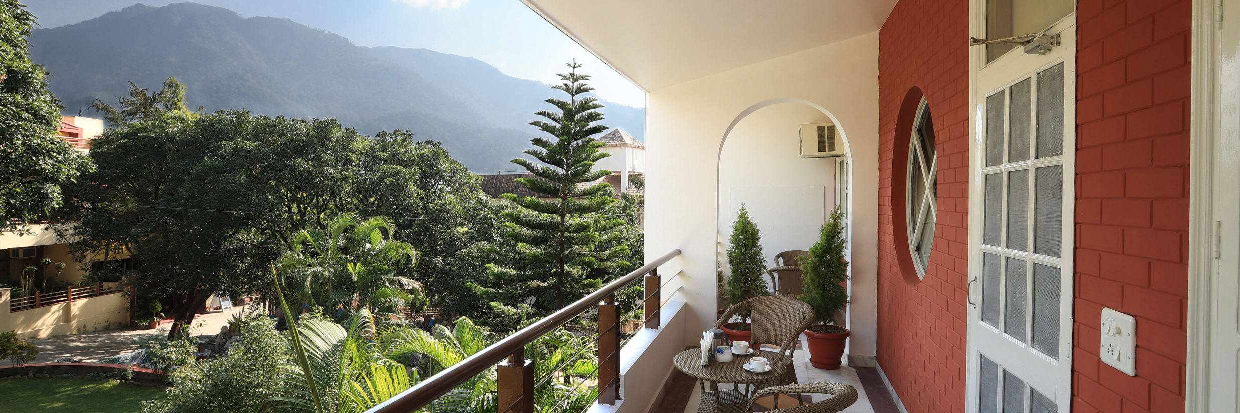 Super Deluxe Room balcony offers a view of the surrounding greenery - Lamrin Boutique Cottages Rishikesh