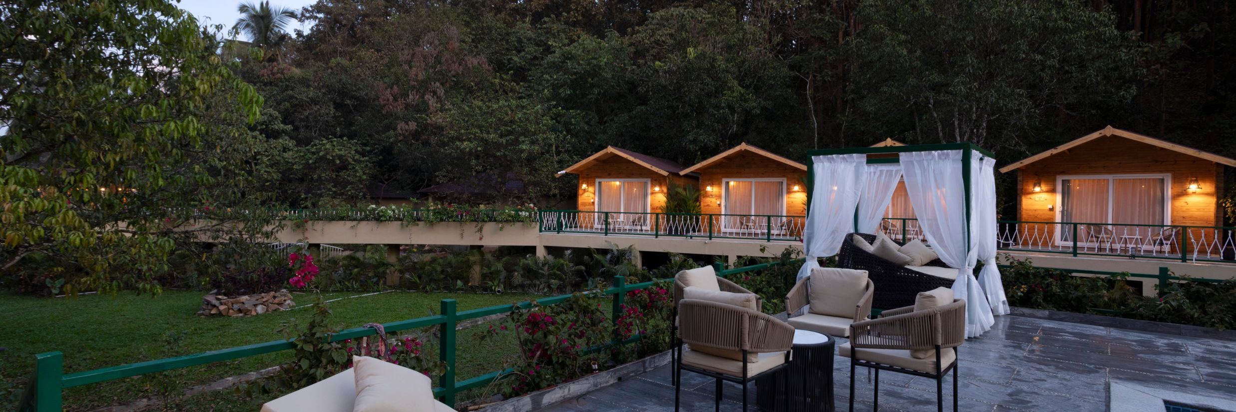 loungers on the side of the swimming pool with trees in the background - Stone Wood Jungle Resort, Dandeli