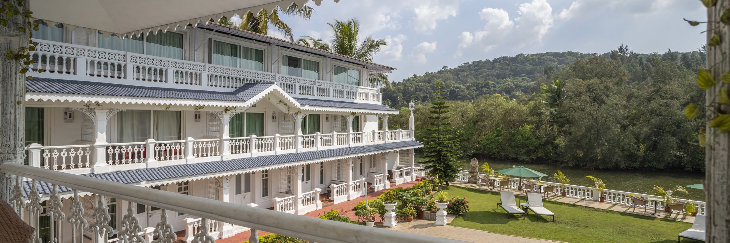 The Maharaja Balcony offers a splendid view of the facade, pool and thick vegetation surrounding the premise - Stone Wood Riverfront Resort, Siolim