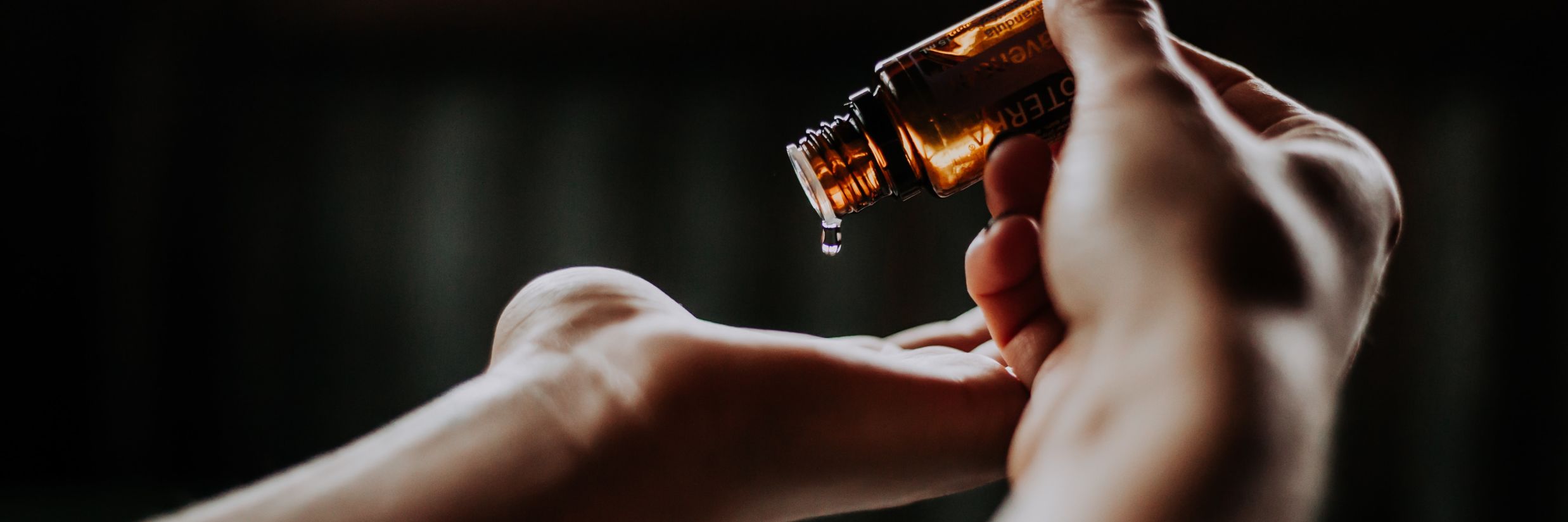 a person using oil from a bottle