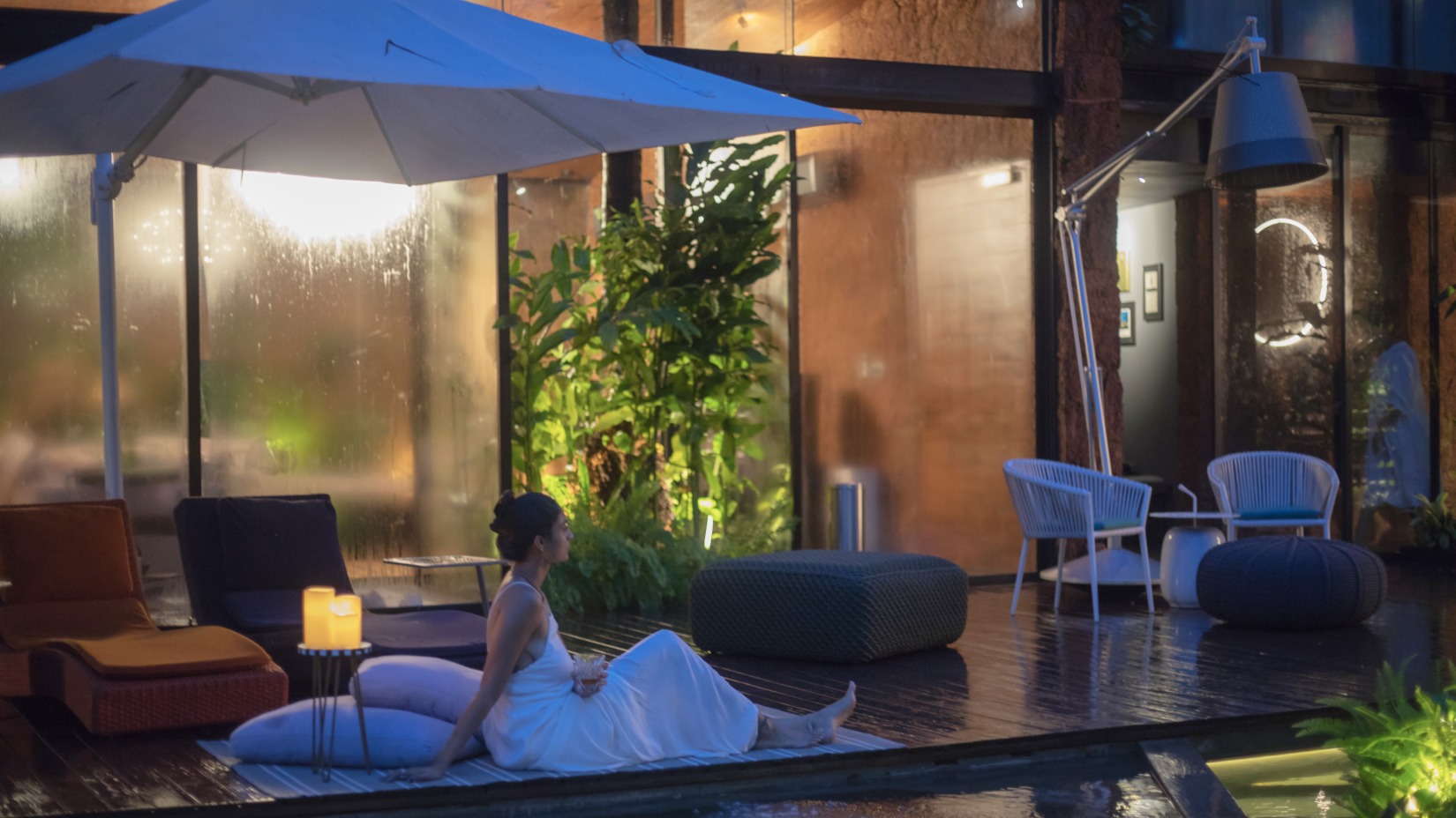 A woman lounges in the poolside area - Experiences at Villa in Palms