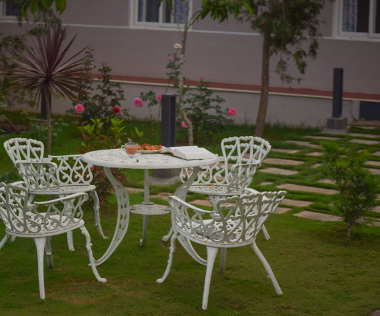 alt-text steel table and chairs on the garden at Ibex Stays & Trails, Kotagiri