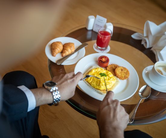 alt-text man eating food at orchid hotel mumbai vile parle