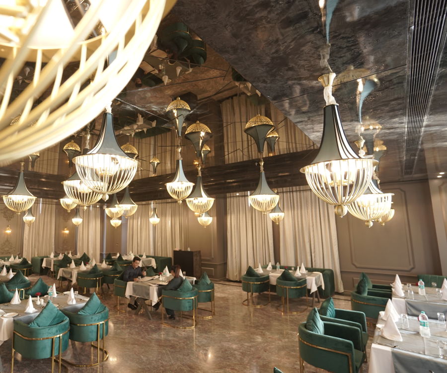 alt-text restaurant with blue chairs and white tables and round lights on the ceiling