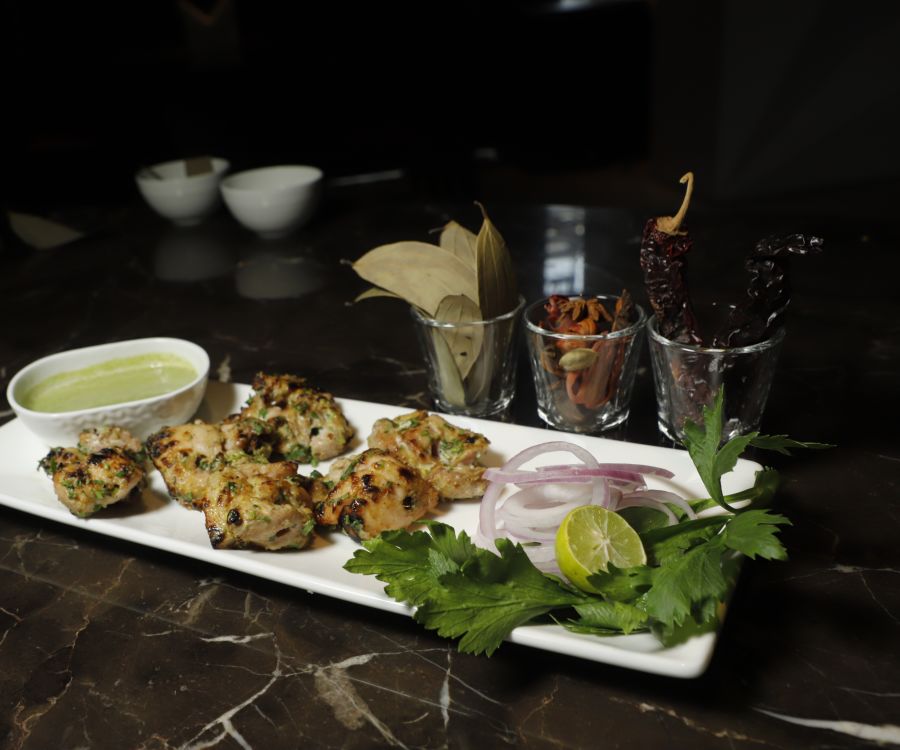 alt-text Udman By Ferns N Petals, Chattarpur - chicken malai tikka kebab at a restaurant table