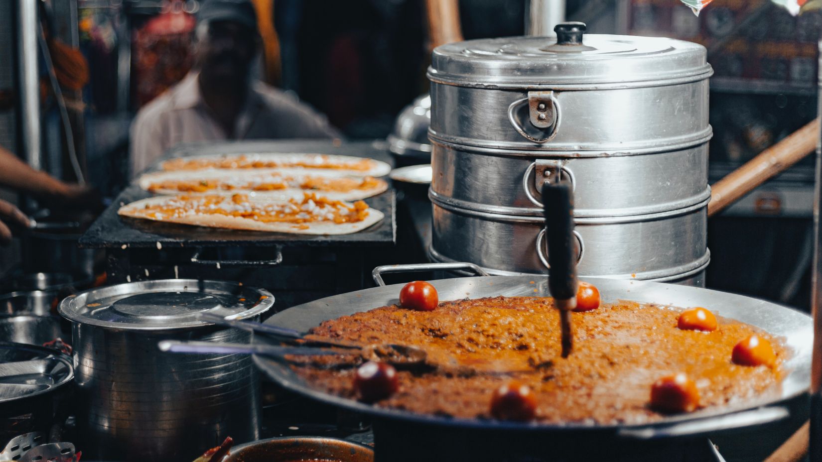 a food stall with lots of food and equipment kept