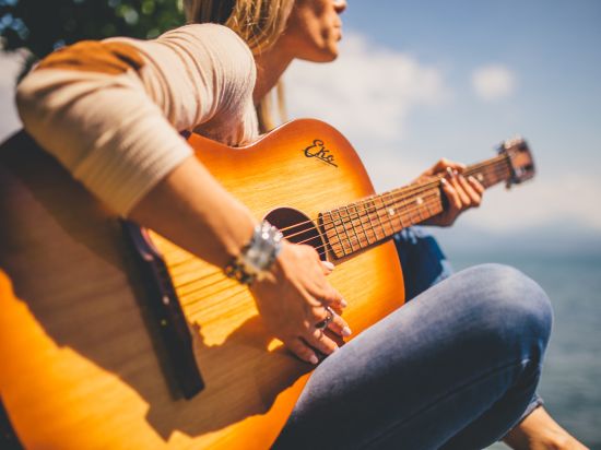 Woman playing a guitar