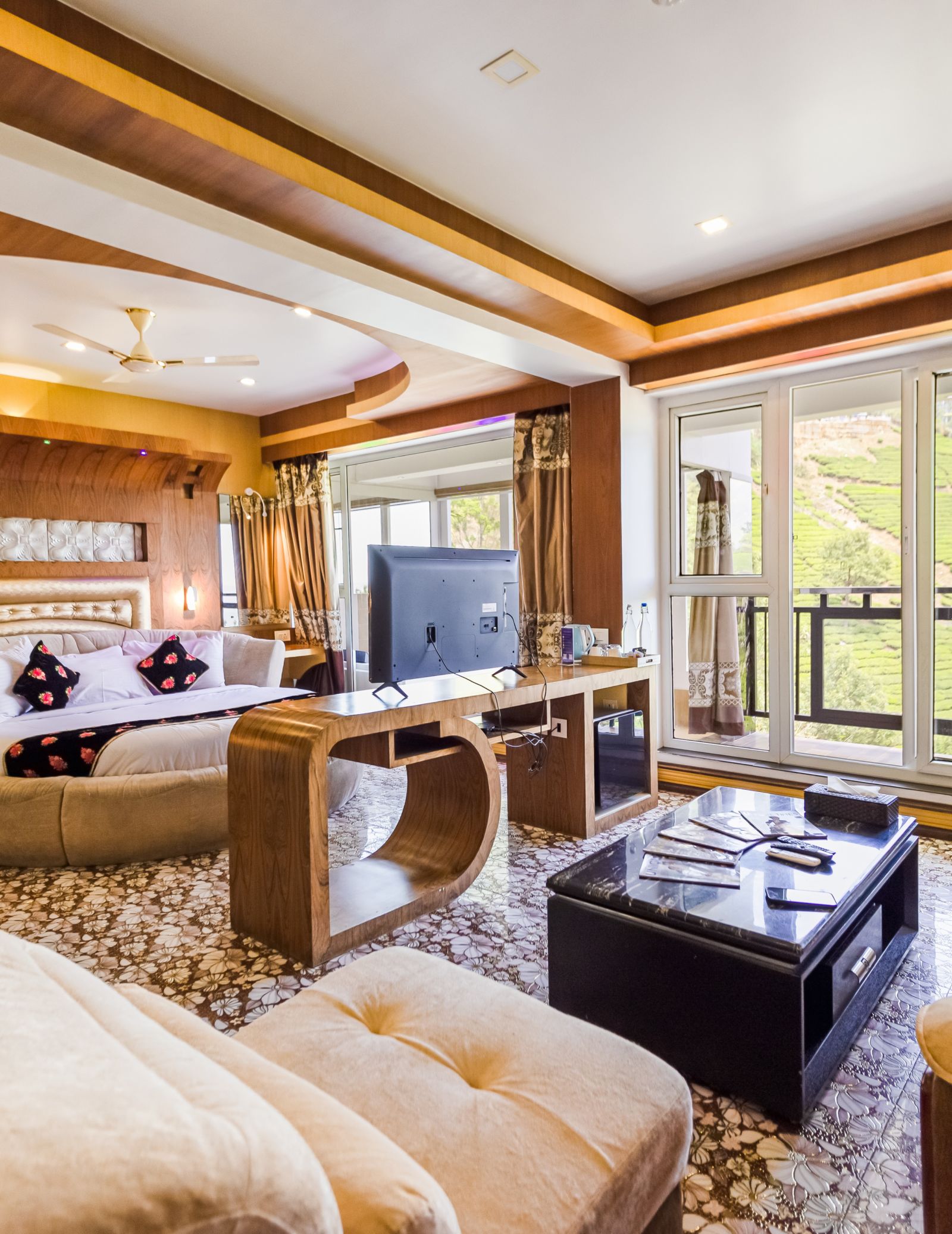 A living area and a round bed in the Honeymoon Suite at Parakkat Nature Hotel and Resorts Munnar 2