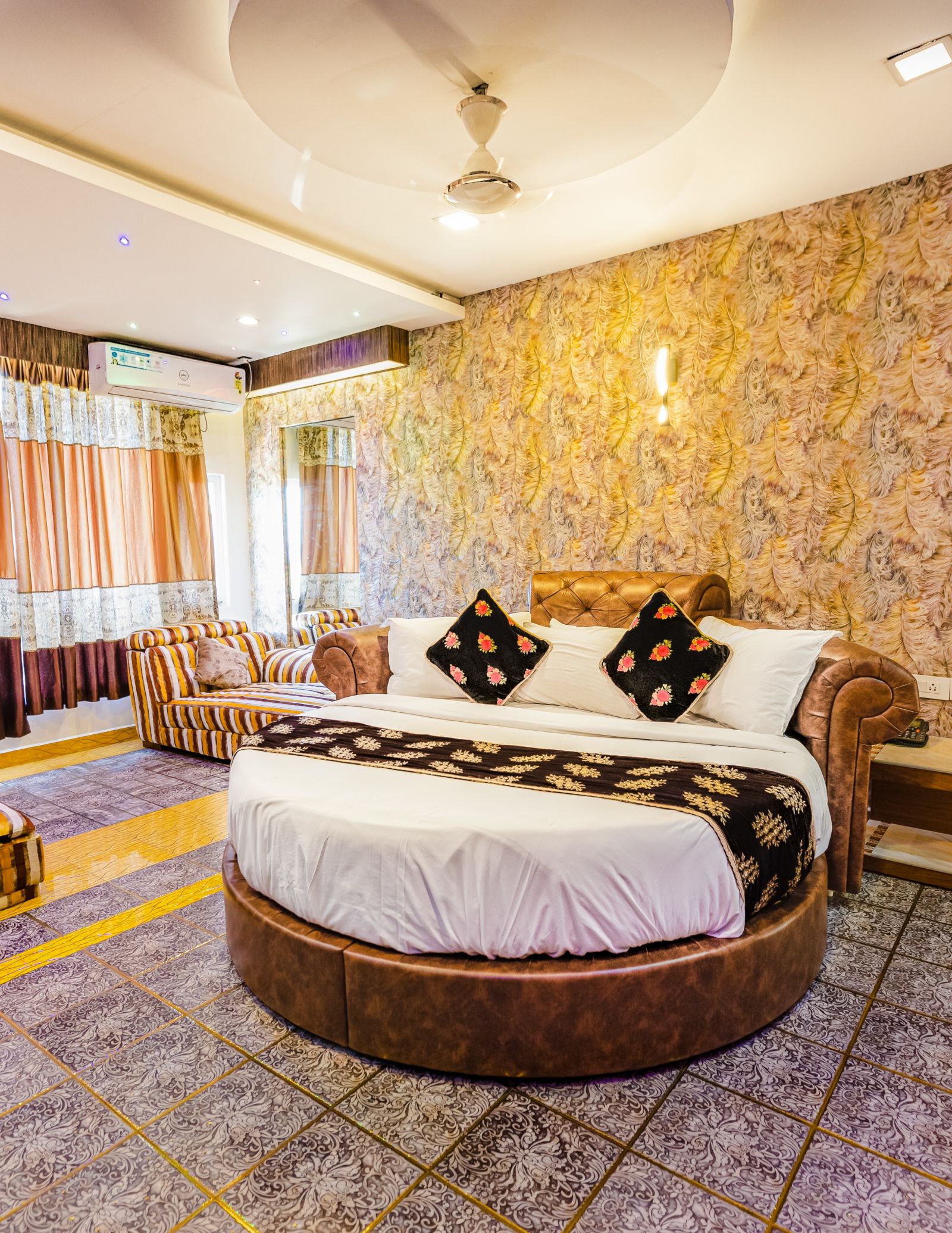 A round bed and sofa in the Jacuzzi Family Room at Parakkat Nature Hotel and Resorts Munnar 2